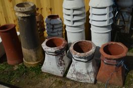 THREE OCTAGONAL TOPPED TERRACOTTA CHIMNEY POTS, two pots painted white, and two cylindrical