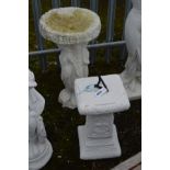 A WHITE PAINTED COMPOSITE BIRD BATH, on a separate base with semi clad classical ladies, diameter