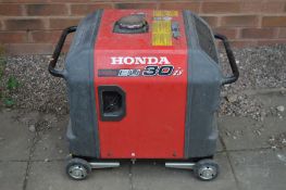 A HONDA EU30 IS 240 VOLT, 16 AMP INVERTER GENERATOR, on casters (no key, engine pulls freely so