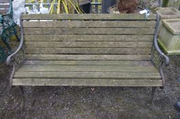 A WROUGHT IRON AND TEAK SLATTED GARDEN BENCH, width 148cm