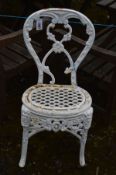 A WHITE PAINTED CAST IRON GARDEN CHAIR with a scrolled floral and scroll detail, and a lattice seat,