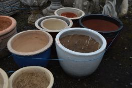 SIX VARIOUS GLAZED PLANT POTS OF VARIOUS COLOURS AND SIZES, largest diameter 47cm x height 34cm