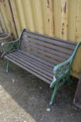 A GREEN PAINTED WROUGHT IRON AND TEAK SLATTED GARDEN BENCH, length 129cm