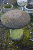 A SANDSTONE STADDLE STONE on circular bases, diameter 61cm x height 74cm (possibly a pair to lot