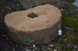 A SANDSTONE MILL WHEEL, diameter 77cm x height 26cm