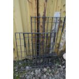 THREE BLACK PAINTED CAST IRON FENCE PANELS, largest panel 122cm x 62cm