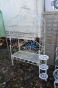 A WHITE PAINTED WROUGHT IRON GARDEN BENCH with an arched overhanging top, width 110cm x depth 51cm x