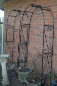 A PAIR OF BLACK FINISH WROUGHT IRON GARDEN ARCH'S with scrollage decoration, width 96cm x depth 31cm