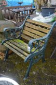 A GREEN PAINTED CAST IRON AND SLATTED SINGLE GARDEN SEAT, width 61cm x depth 68cm x height 71cm (