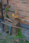 A 51 KILO CAST IRON ANVIL, on original stand and four ironmongery tools (5)