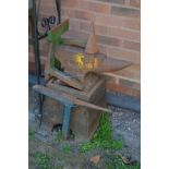 A 51 KILO CAST IRON ANVIL, on original stand and four ironmongery tools (5)