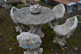 A COMPOSITE TREE FORM GARDEN TABLE with a central removable bowl of fruit to reveal a parasol