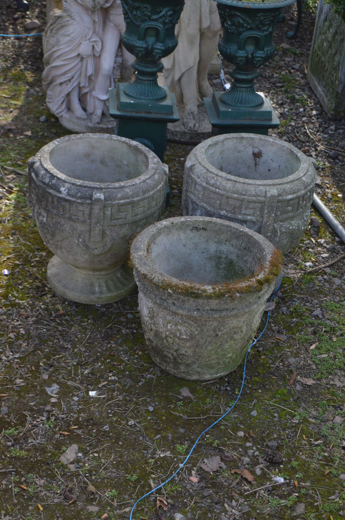 A PAIR OF WEATHERED COMPOSITE GREEK CIRCULAR PLANTERS, diameter 37cm x height 38cm and another