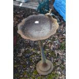 A CAST IRON BIRD BATH, with a wavy top and humming bird to the top edge, diameter 37cm x height