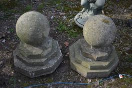 A PAIR OF WEATHERED COMPOSITE SPHERE FINIALS, on stepped separate octagonal base, diameter 39cm x