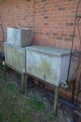 TWO GALVANISED WATER CONTAINERS, with lids, taps, on a separate cast iron stand, width 92cm x