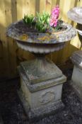 A LARGE WEATHERED RECONSTITUTED STONE CAMPANA GARDEN URN, on a separate square plinth base, diameter