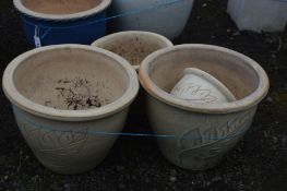 FIVE SIMILAR CREAM GLAZED PLANT POTS, of various sizes, largest diameter 38cm x height 31cm