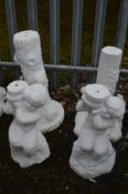 TWO SIMILAR WHITE PAINTED COMPOSITE GARDEN FIGURES, of a putto (possibly a water feature, and