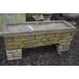 A RECTANGULAR COMPOSITE BRICK EFFECT GARDEN PLANTER, on matching separate supports, marked