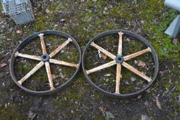 A PAIR OF VINTAGE CAST IRON CART WHEELS, diameter 62cm