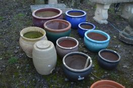 EIGHT VARIOUS SIZED GLAZED PLANT POTS, largest pot diameter 51cm x height 30cm along with a