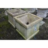 A PAIR OF COMPOSITE SQUARE AND REEDED GARDEN PLANTERS, 46cm squared x height 43cm