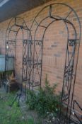 A PAIR OF BLACK FINISH WROUGHT IRON GARDEN ARCH'S, with foliate decoration, inner width 94cm x outer