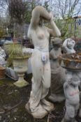 A COMPOSITE GARDEN FIGURE OF A STANDING SEMI CLAD LADY with flowing robes, height 116cm