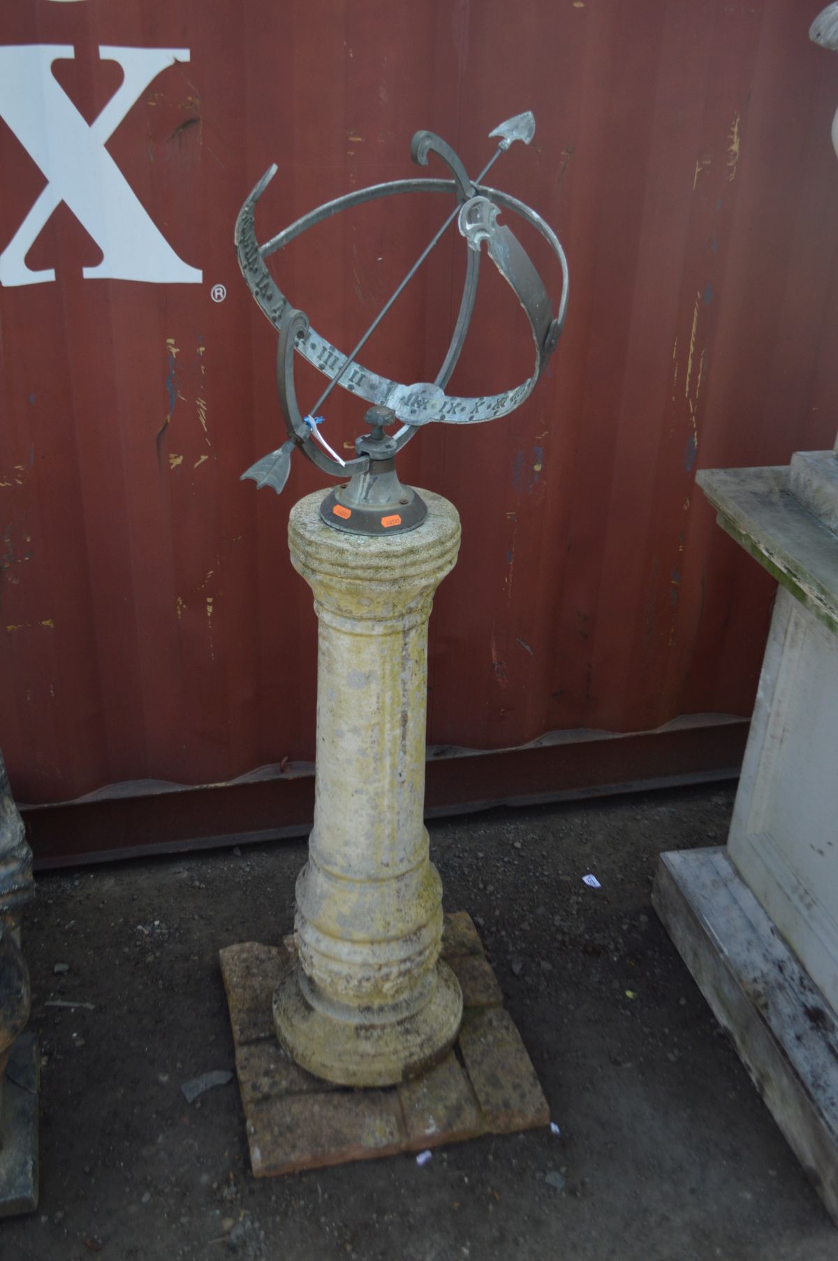 AN ARMILLARY SUNDIAL on a weathered composite cylindrical column, and a later brick effect base,