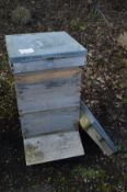 A BRITISH NATIONAL CEDERWOOD BEE HIVE, height 97cm and one spare lid