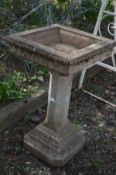 A SQUARE COMPOSITE BIRD BATH on an octagonal support and stepped base, 53cm x 89cm