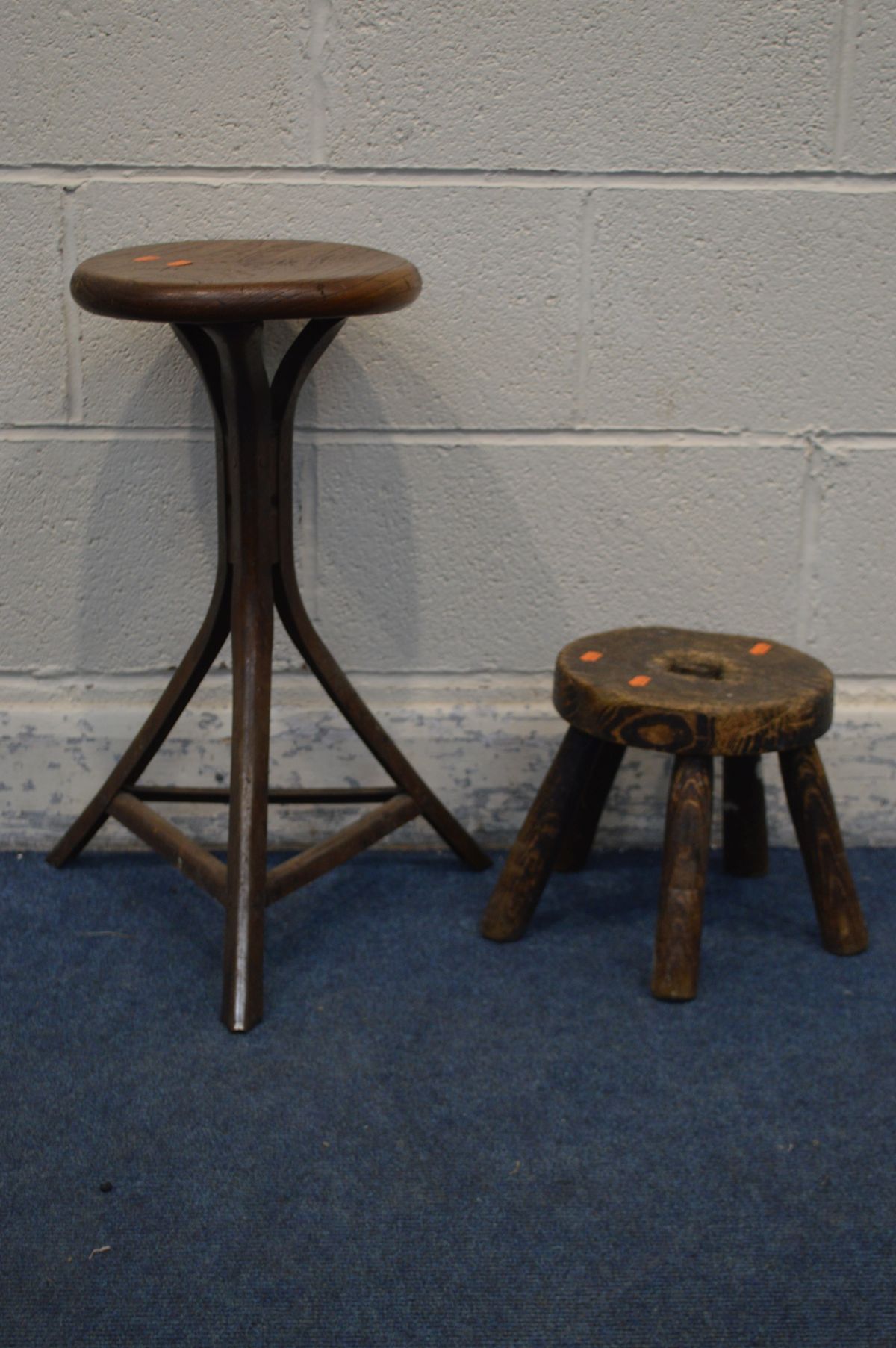 AN INDUSTRIAL OAK TOPPED STOOL, height 56cm and an elm five legged milking stool (2)