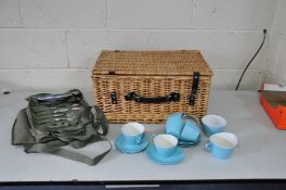 A WICKER PICNIC BASKET with leather straps 50cm wide x 36cm deep x 25cm high, containing a Gayden