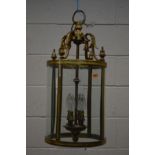 A BRASS CYLINDRICAL HALL LANTERN, with rounded glass panels, diameter 26cm x drop 57cm