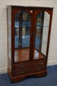 A CHERRYWOOD TWO DOOR DISPLAY CABINET, above two drawers, width 91cm x depth 45cm x height 161cm