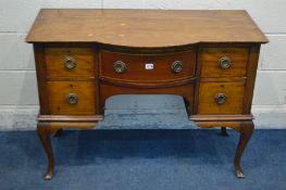 AN EDWARDIAN MAHOGANY AND STRUNG INLAID BOW FRONT LADIES DESK, with five various drawers, on