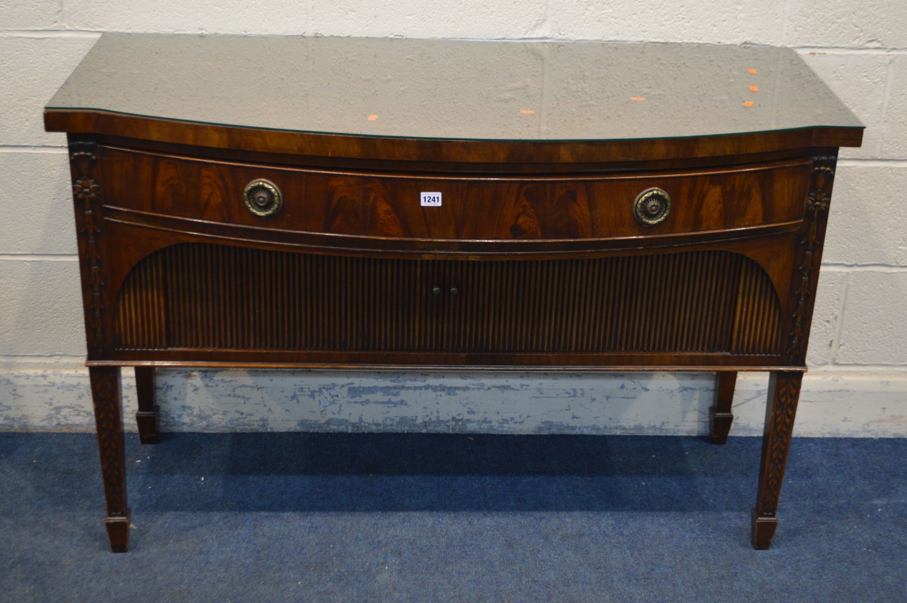 A GILL AND REIGATE OF LONDON MAHOGANY BOW FRONT SIDEBOARD/SERVING TABLE, with a single frieze