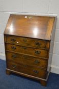 A SLIM OAK BUREAU with four drawers, width 73cm x depth 39cm x height 105cm