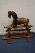 A LATE 20TH CENTURY WOODEN ROCKING HORSE, a trestle base, with main and tail hair, and leather