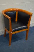 A REPRODUCTION CHERRYWOOD AND BLACK FAUX LEATHER UPHOLSTERED TUB CHAIR