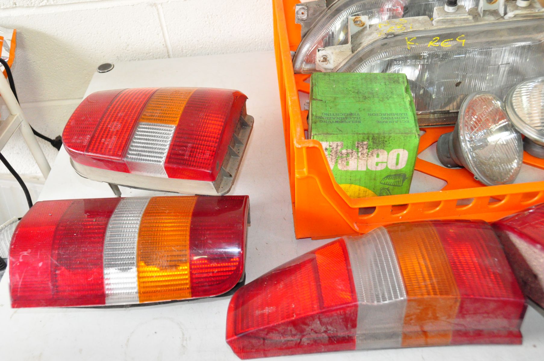 A TRAY CONTAINING VINTAGE CAR HEAD AND TAIL LIGHTS including a brand new old stock SAP Ford Sierra - Image 2 of 5