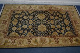 A FLORAL WOOLLEN RUG, with a gold field, 280cm x 184cm