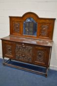 AN EARLY 20TH CENTURY OAK MIRRORBACK SIDEBOARD, with detailed carved panels, barley twist front