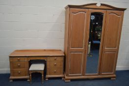 A BLEACHED PINE THREE PIECE BEDROOM SUITE, comprising three door wardrobe with a central mirror