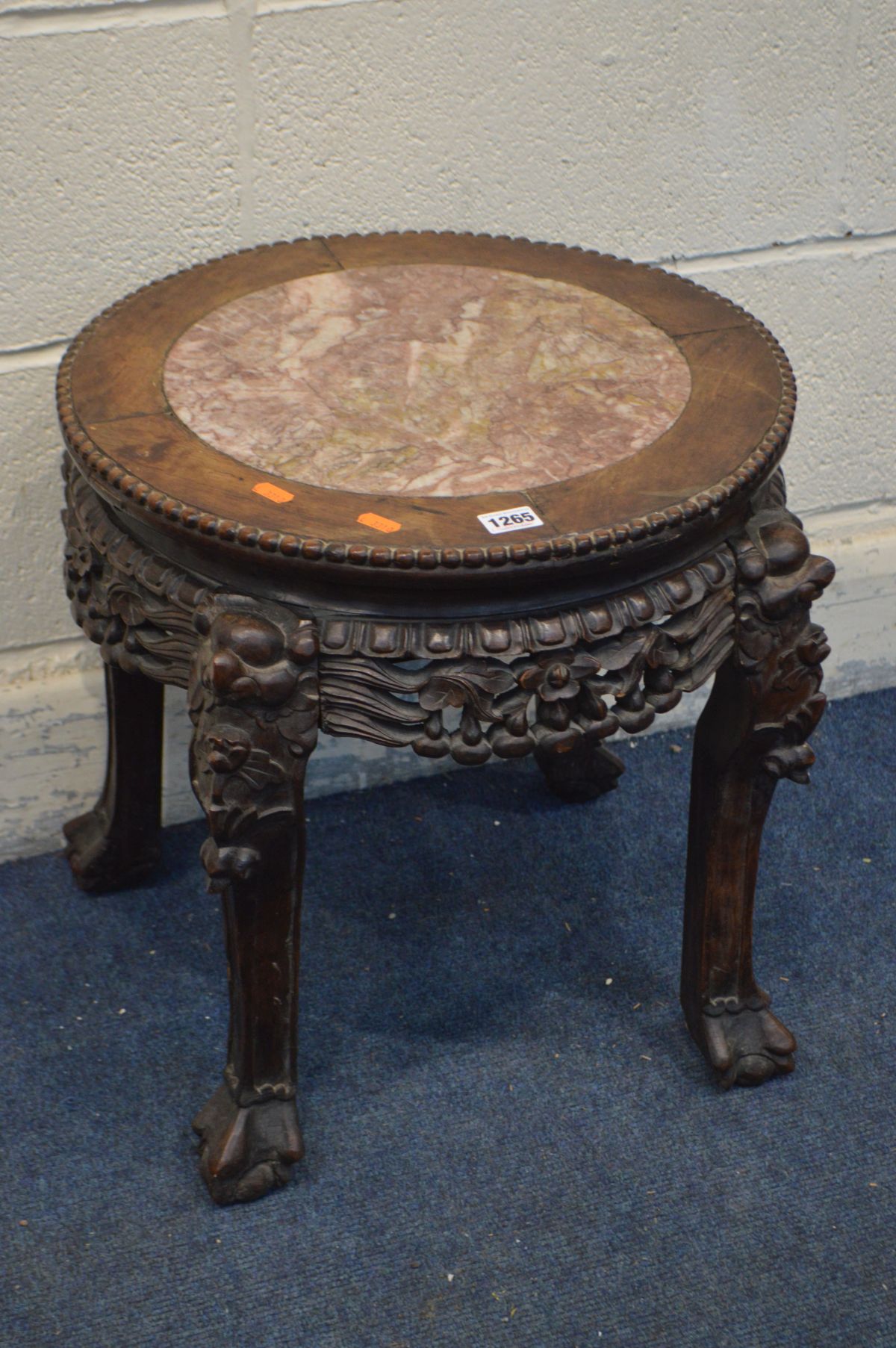 AN ORIENTAL ROSEWOOD OCCASIONAL TABLE with a pink marble insert, and elaborate carving, diameter