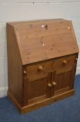 A PINE BUREAU, with a fitted interior and two drawers, width 88cm x depth 47cm x height 109cm (key)