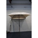 A PAIR OF LARGE GARDEN PARASOLS with Laurent-Perrier to canvas 190cm square at top and 210cm tall