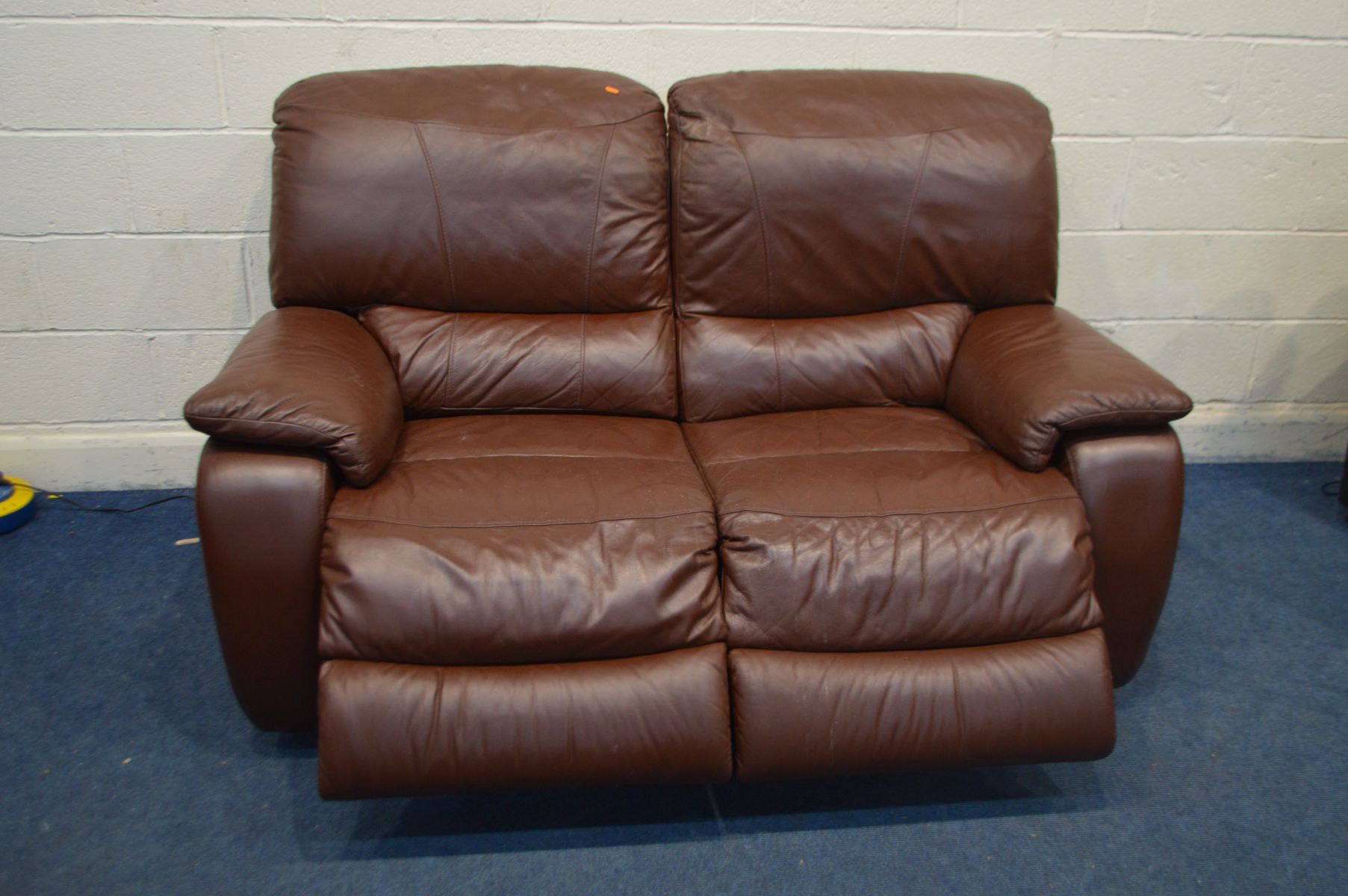 A BURGUNDY LEATHER TWO SEATER ELECTRIC RECLINING SOFA, width 166cm and an ottoman pouffe (PAT pass - Image 2 of 2