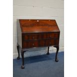 A MAHOGANY LADIES BUREAU with a fitted interior, three various drawers, on cabriole legs and ball